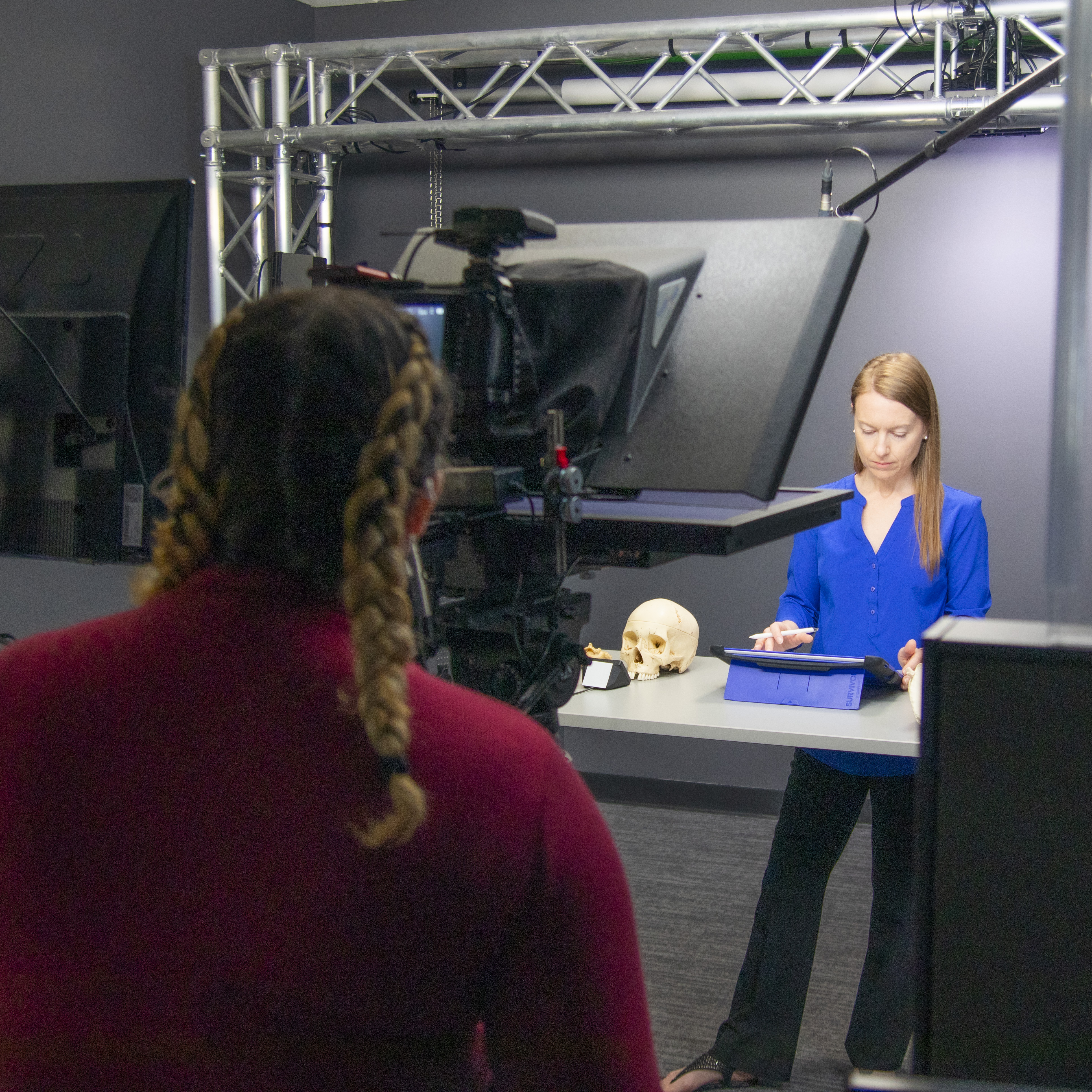 A professor recording a lecture in the AMP studios.