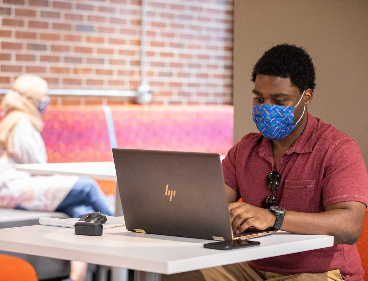 student with laptop facing forward